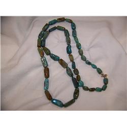 A Turquoise bead  Necklace w/ sterling silver clasp. Necklace measures 40 In long