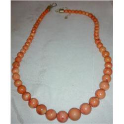 A Salmon Colored Coral bead necklace w/ a sterling silver clasp