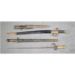 Lot of four European military bayonets, three  with scabbards and all in uncleaned  condition.  Est.