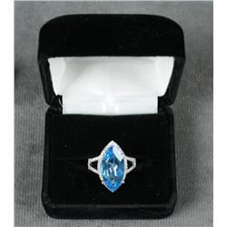 One 14k white gold ladies ring set with a 7ct  marquee blue topaz and 0.31ct of diamonds.  Est. $1,0