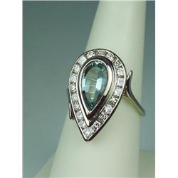 Dazzling 14 karat white gold ladies handmade  ring bezel set with a center pear shape blue  Aquamari