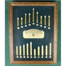 Glass and wood framed display of example  Sharps Rifle cartridges entitled “The Buffalo  Hunter” by 