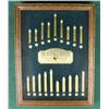 Image 1 : Glass and wood framed display of example  Sharps Rifle cartridges entitled “The Buffalo  Hunter” by 