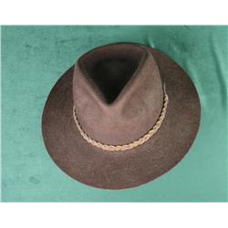 Orvis Bison cowboy hat with leather band and  wood stand in overall very good condition.    Est.:  $