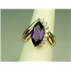 Image 1 : High quality 14 karat yellow gold ladies  custom made ring set with a very fine MQ cut  intense purp