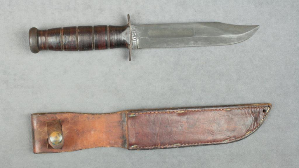 “USMC”marked KaBar knife with leather grip and tan leather sheath in