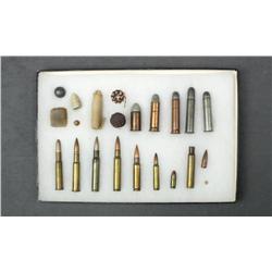 Small collector’s lot of military example  cartridges and misc. items in riker case  including two t