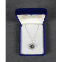 One beautiful filigree design 14kt white gold  pendant set with black pearl and diamonds.  Est. $1,0