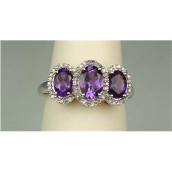 Dazzling 10 karat white gold ladies designer  ring set with three matching oval Amethyst  weighing a