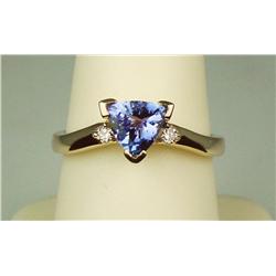 High quality 14 karat yellow gold ladies  handmade ring set with a center fine  trilliant cut Tanzan