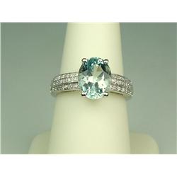 Gorgeous 14 karat white gold ladies ring set  with a center fine oval Aquamarine weighing  approx. 3