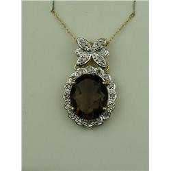 Dazzling 10 karat yellow gold ladies pendant  set with an oval smoky topaz weighing approx.  4.00 ca