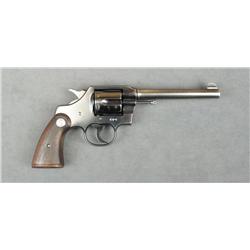 Colt Official Police DA revolver, .38 cal.,  6” barrel, blue finish, checkered medallion  wood grips