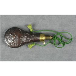 Beautiful later brass shotgun flask with  embossed game scenes and hanging cord in  overall very goo