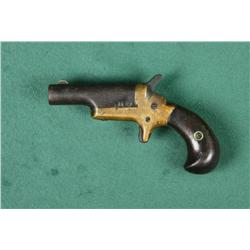 Colt single shot derringer, .41 cal., iron  barrel, brass frame, wood grips, #NVSN.  This  gun is in