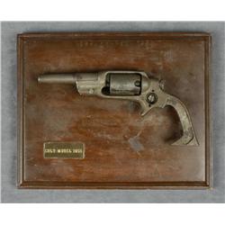 Relic Colt Root percussion revolver on  display board.  Est.:  $100-$200.