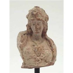 A Romanesque carved marble bust of a girl,...