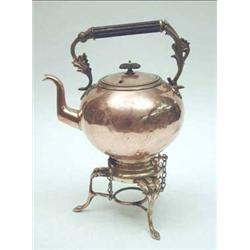 A Victorian copper tea kettle, hinged upon...