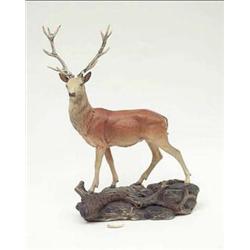A Beswick figure of a stag standing on a...