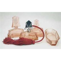 An Art Deco 4-piece pink glass dressing...
