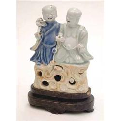 A Chinese porcelain group of 2 seated...
