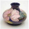 Image 1 : A Moorcroft squat vase with magnolia on a...