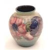 Image 1 : A small Moorcroft vase with anemones on a...