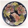 Image 1 : A Moorcroft plate with clematis on a dark...