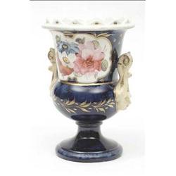 A Victorian spill vase with mask handles on...