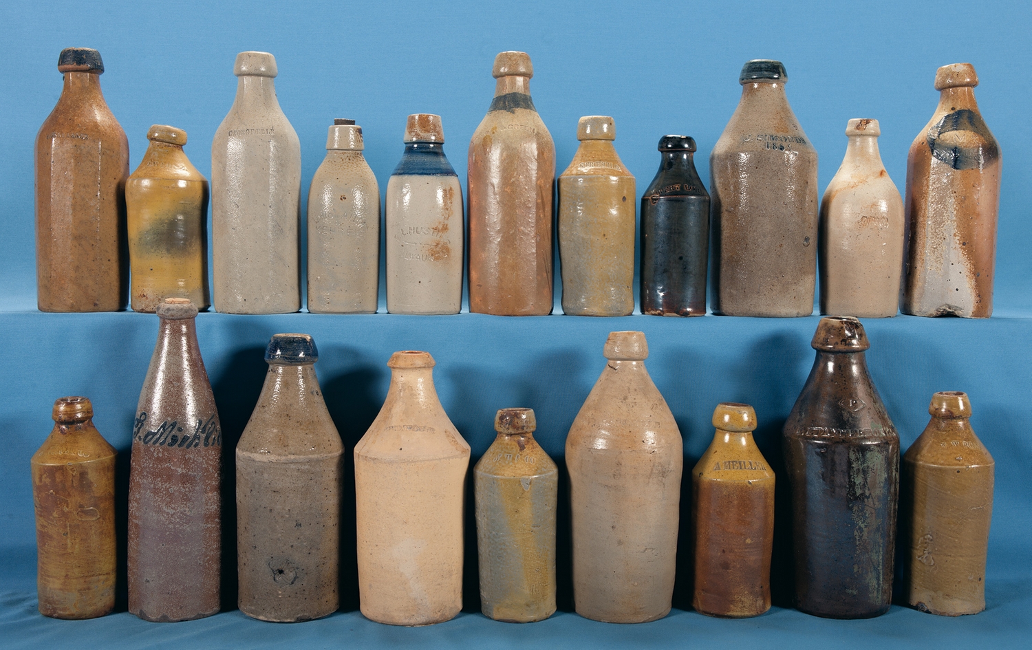 Lot of Twenty Stoneware Liquor Bottles from Eastern and Midwestern Region