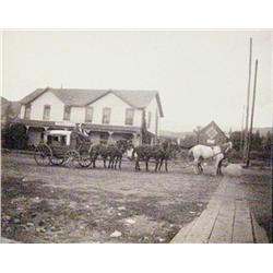 Photograph of stage in front of Sheridan House in Wyoming, mounted, 3 ¾” x 4 ¾”.