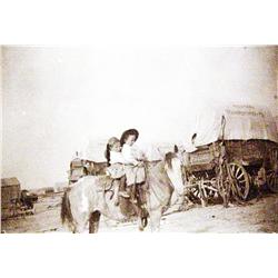 Original mounted photo of two children on horseback in front of Niobrara Transportation Co.,