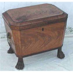 A REGENCY MAHOGANY SARCOPHAGUS SHAPED CELL...