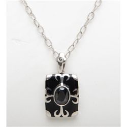 Onyx piece inlaid with silver design and oval  garnet on a oval sterling silver chain.  Est.: $200-$