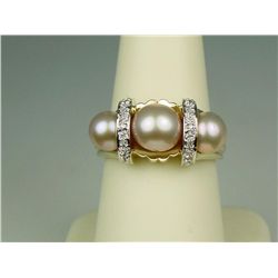 Very fine 14 karat yellow gold ladies  contemporary design ring set with three round  peach color pe