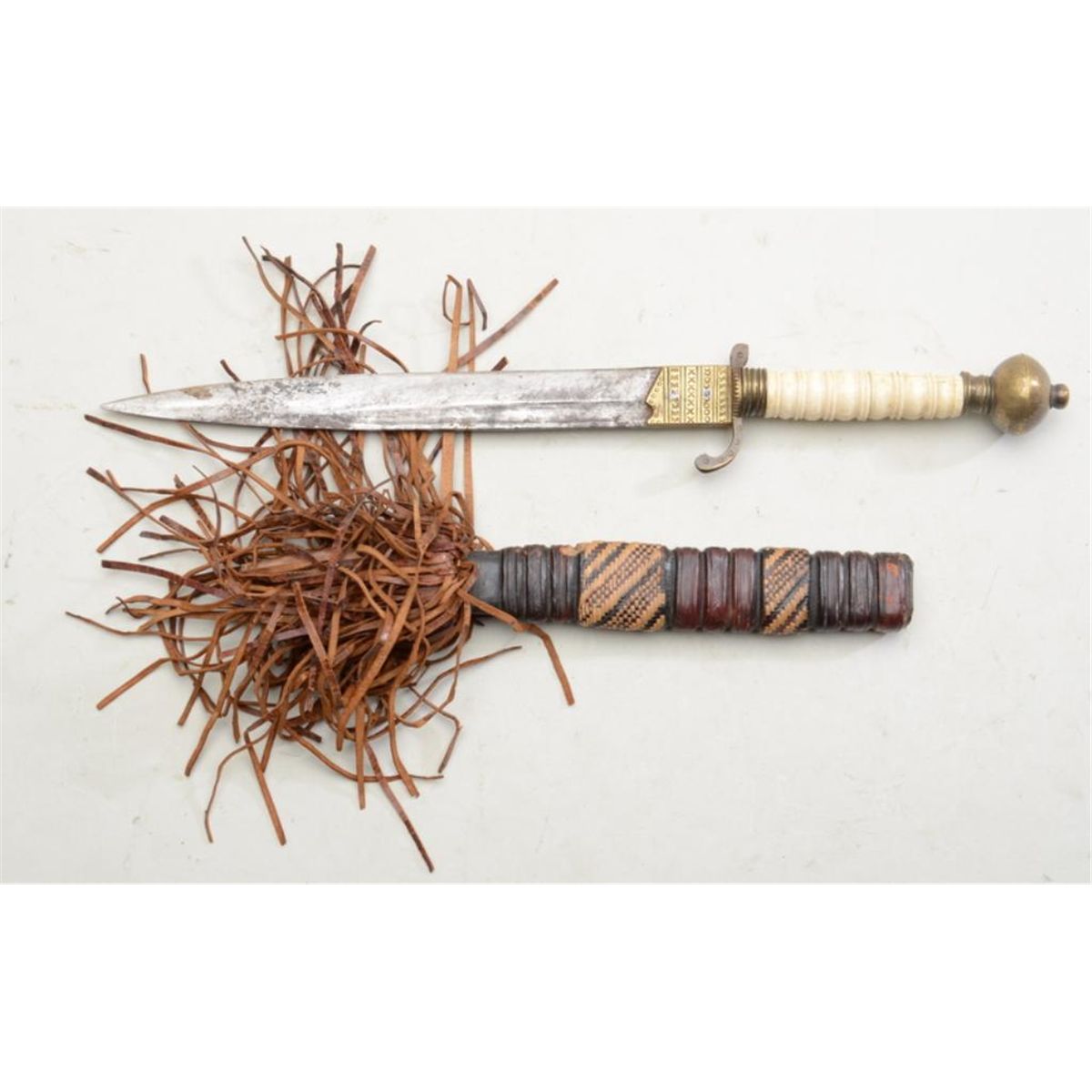 Older African knife with decorative brass hilt, cross guard and pommel