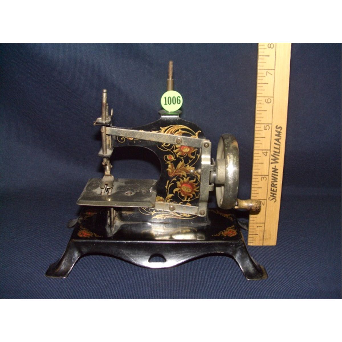 antique child's hand crank metal sewing machine made in Germany, great litho's