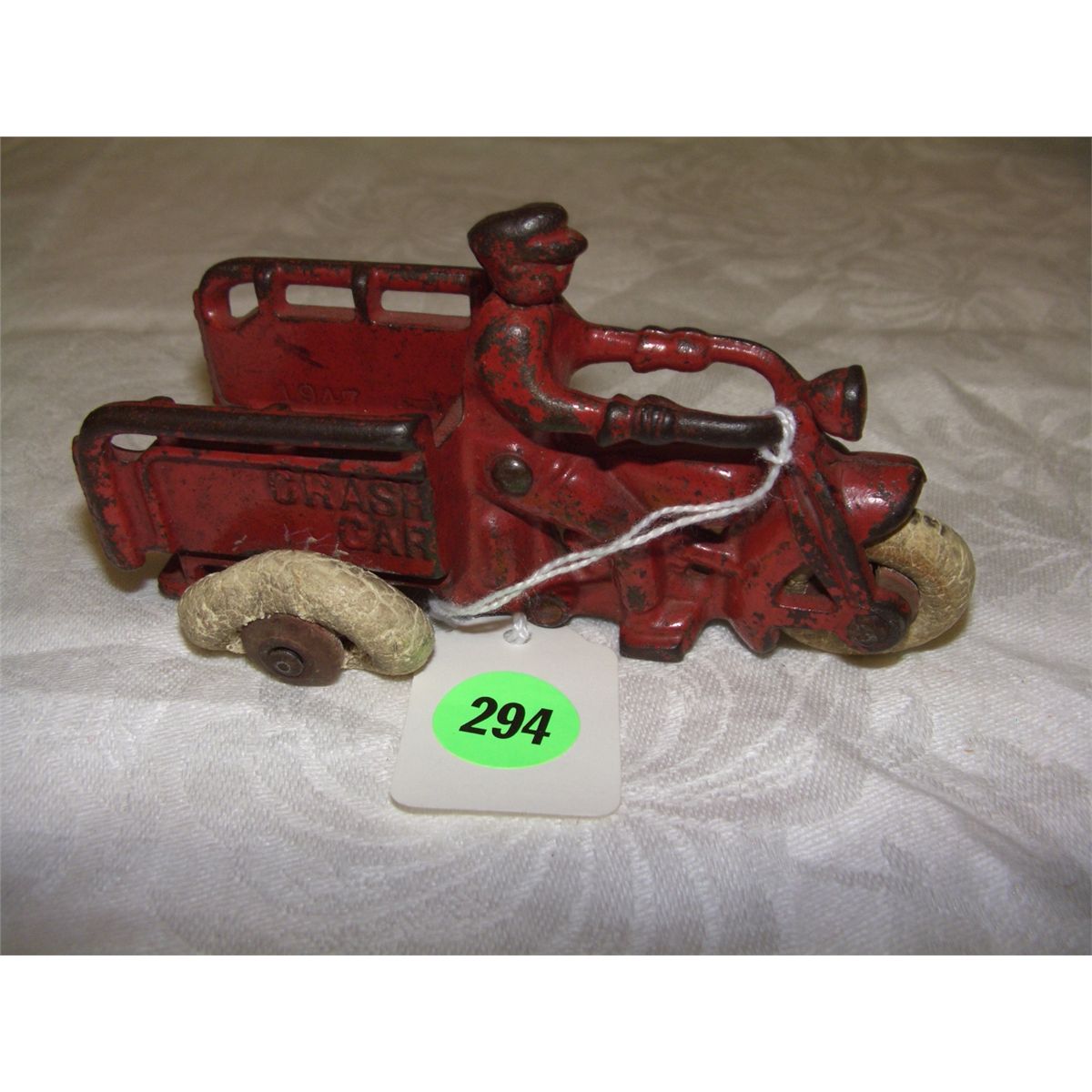 antique cast iron toy crash car toy motorcycle and driver wheels as seen