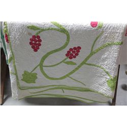 APPLIQUE QUILT. Cotton quilt with red and green applique in a floral and foliate motif with flowers 