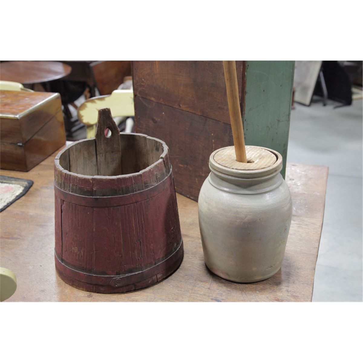 WATER BUCKET AND A SMALL STONEWARE CHURN. Red stained water bucket with ...