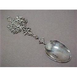 Silver serving spoon, repousse handle depic