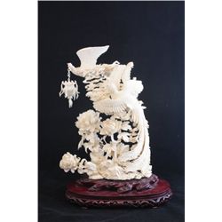 Heavily carved Chinese ivory on rosewood base