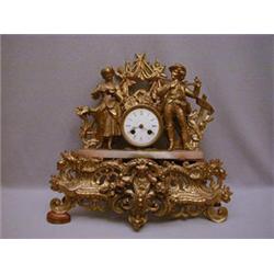 A GILT METAL MANTEL CLOCK
