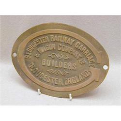 AN OVAL BRASS RAILWAY WAGON PLAQUE