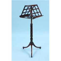 A LATE REGENCY MAHOGANY DUET STAND, the lattice work double slopeing top, supported on an ajustable 