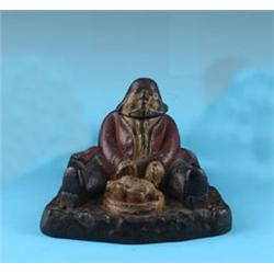 A LATE NINETEENTH CENTURY CAST IRON INKWELL, in the form of a rotund man seated and carving a turkey