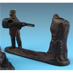 AN AMERICAN CAST IRON NOVELTY MONEY BANK, late nineteenth century, in the form of a soldier holding 