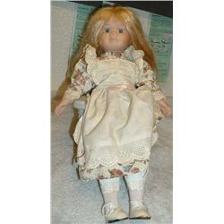 Vintage baby doll Ceramic head, hands and legs.  Sitting in ceramic rocking chair.