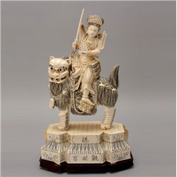 A Carved Ivory Figure Riding a Beast*