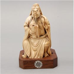 A Carved Ivory Seated Figure*